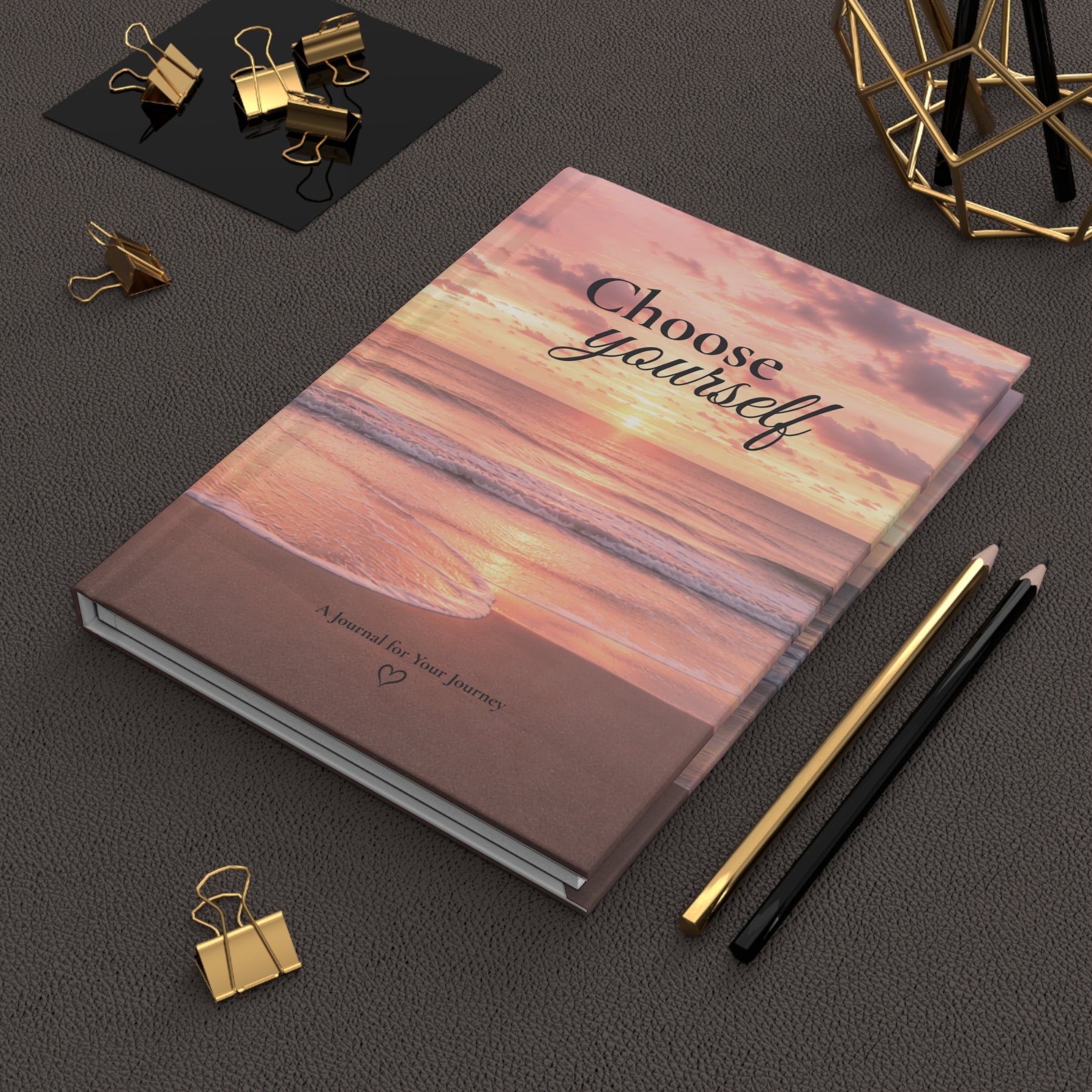 Choose Yourself journal on a dark desk beside pencils and binder clips