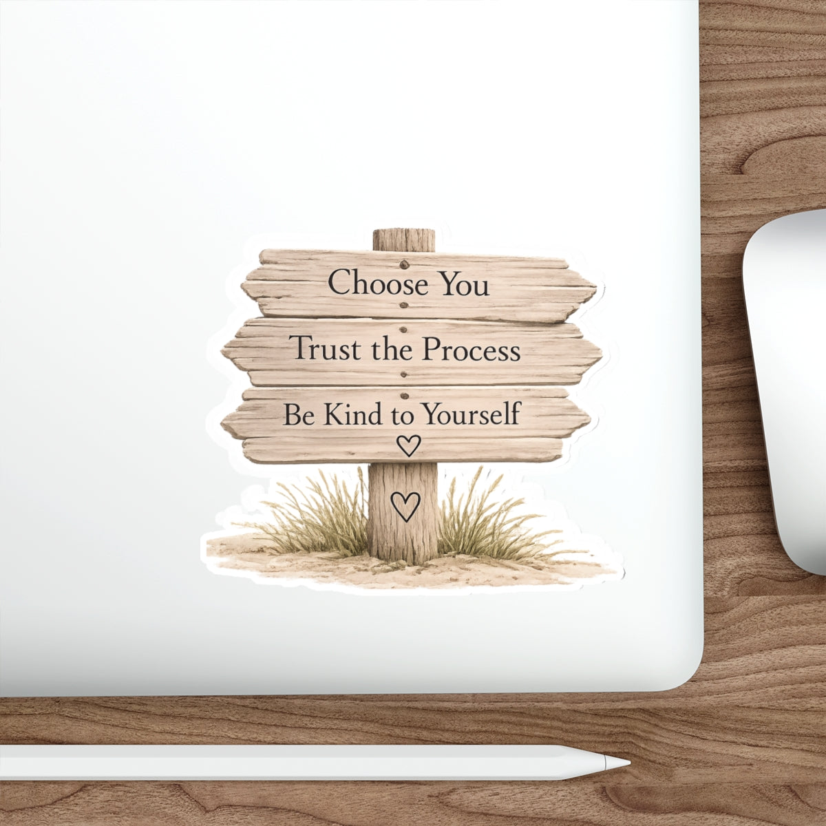 Close view of the wooden beach sign quote sticker on a silver laptop